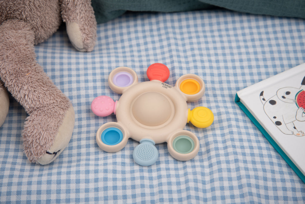 Rainbow pop baby teether with beige center and pastel colored rings