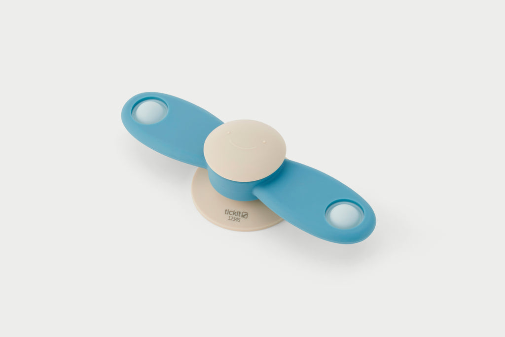 Blue propeller spinner toy with beige center and two circular end grips