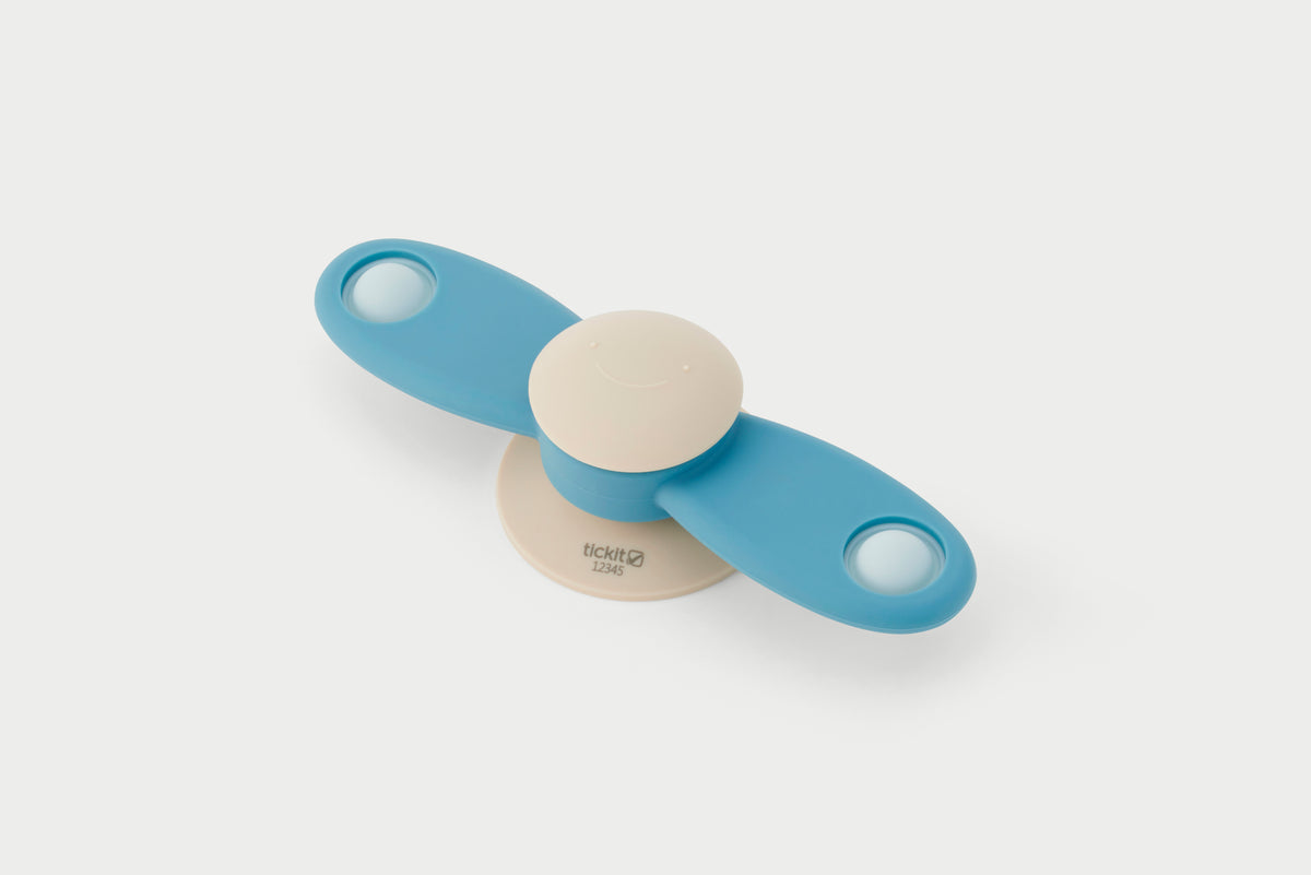Blue propeller spinner toy with beige center and two circular end grips