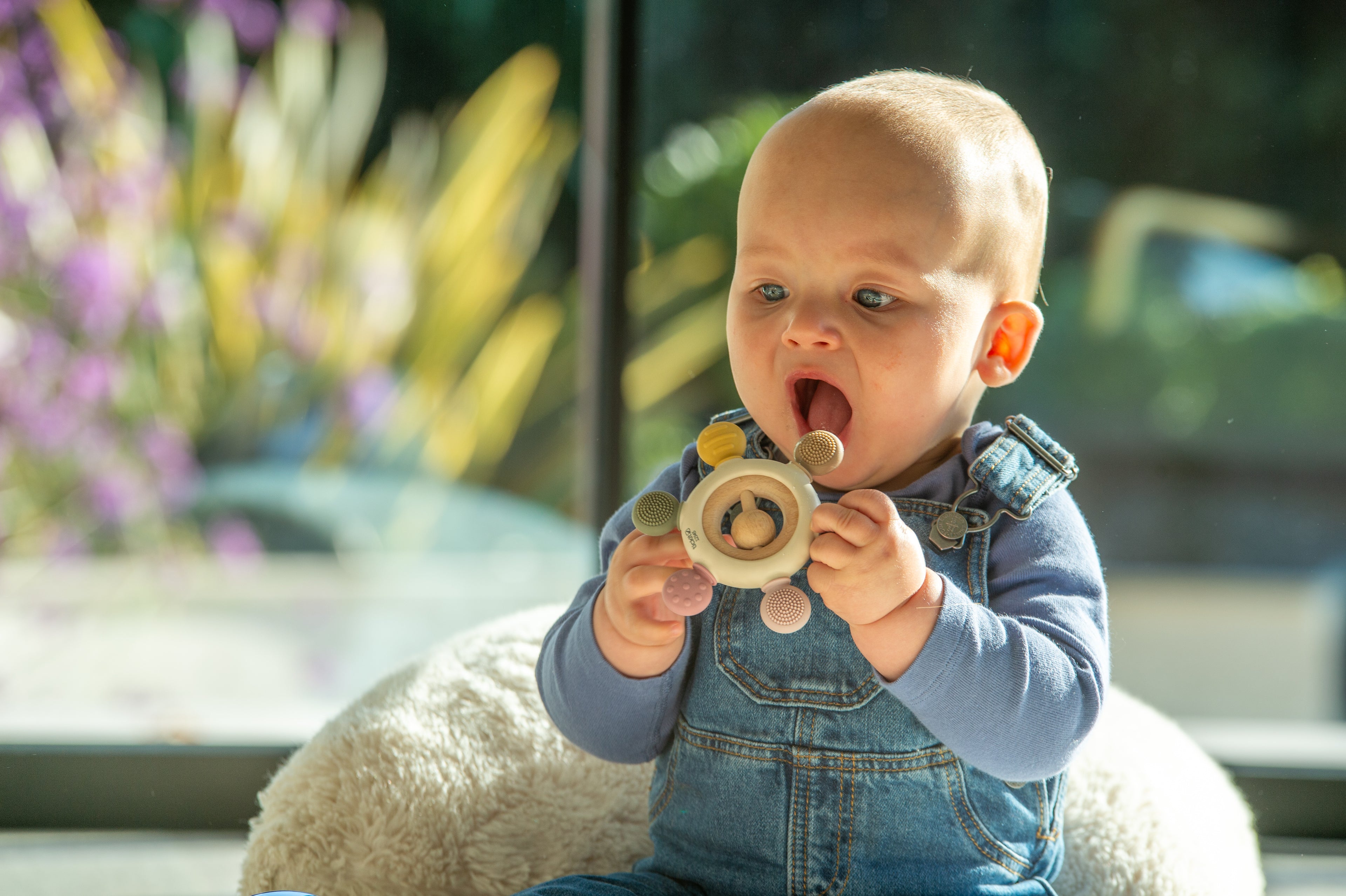 Baby chewing wooden ring rattle teether with round fabric details