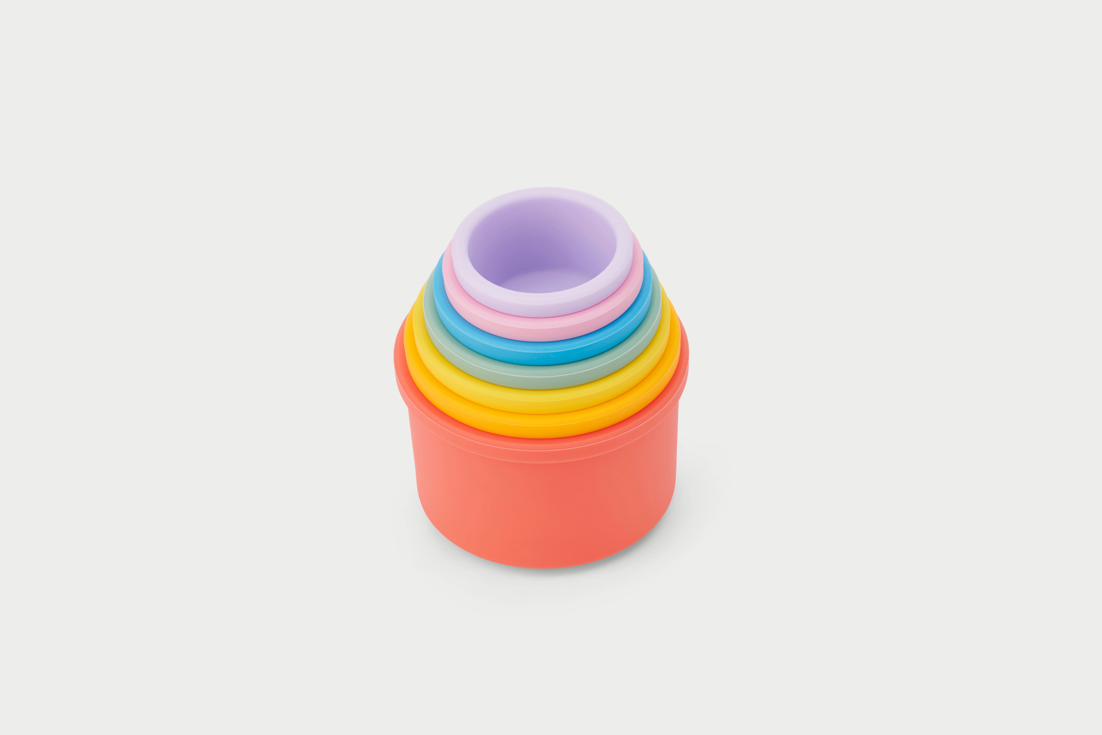 Rainbow silicone stacking cups with nested rings and orange base