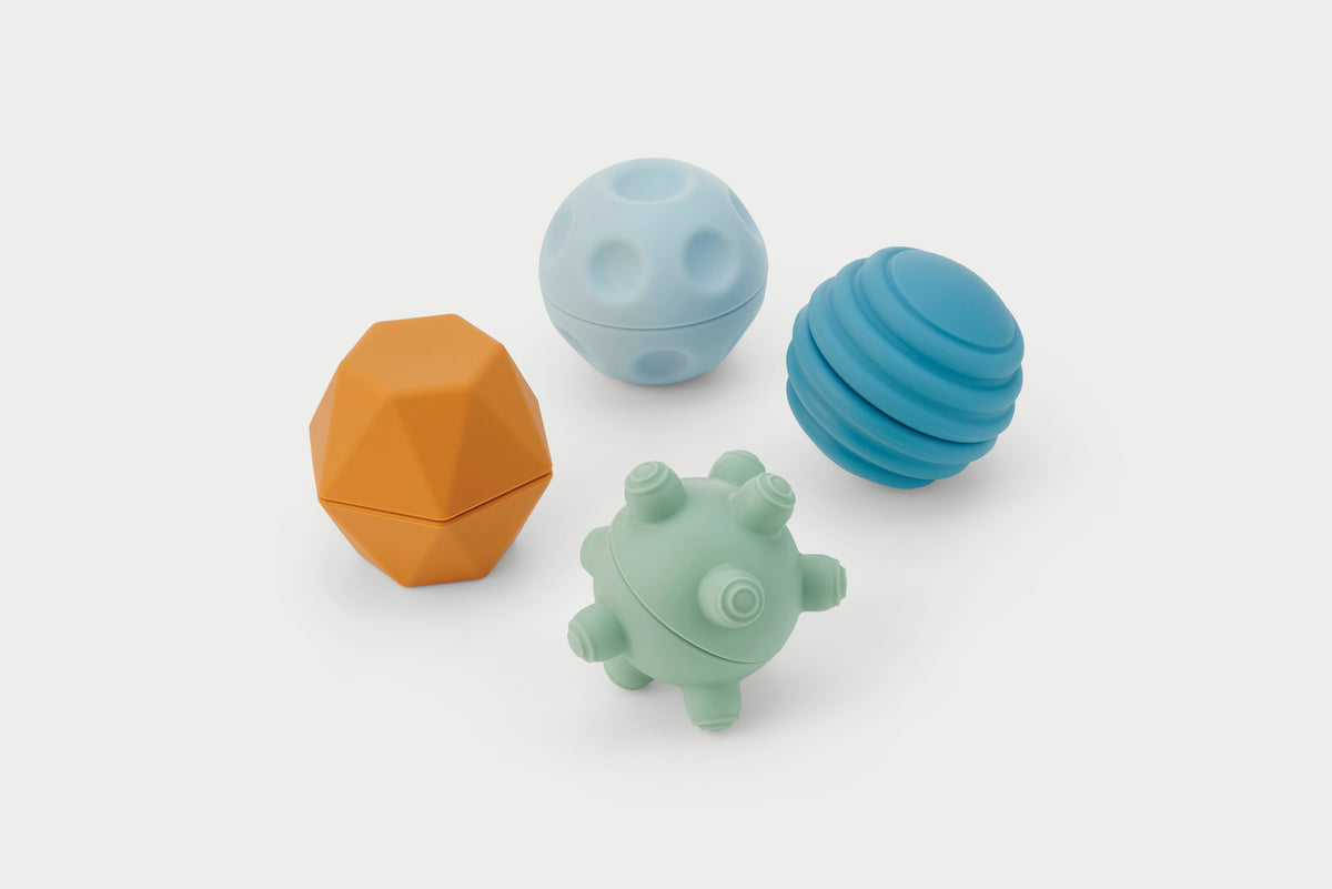 Silicone sensory balls and shapes: blue ribbed sphere, mint creature, orange faceted ball