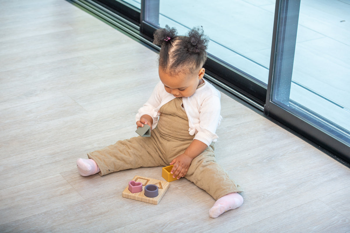 Silisoft shape puzzle set on floor with small wooden board and silicone shapes