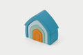 Stacking house toy with teal frame, mint arch, and orange door