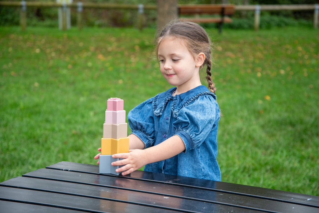 Pastel stacking star cups set, vertical stack in pink, tan, and blue layers.
