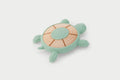 Mint green turtle-shaped silicone teether with wood-look textured shell