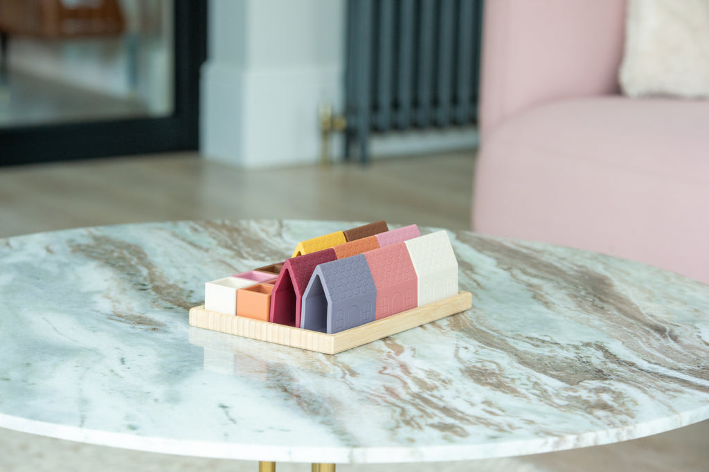 Village blocks set of house-shaped silicone pieces on a small wooden tray