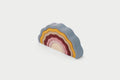 Rainbow stack toy shaped like an earth, with wavy tier layers in multiple colors