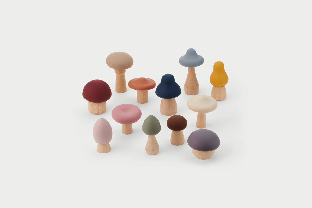 Assorted wooden mushroom stacking pieces in earth-tone colors, mixed tops and stems