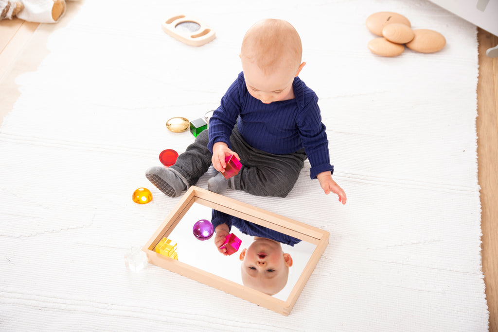 Small wooden mirror tray with mirrored bottom and colorful building blocks