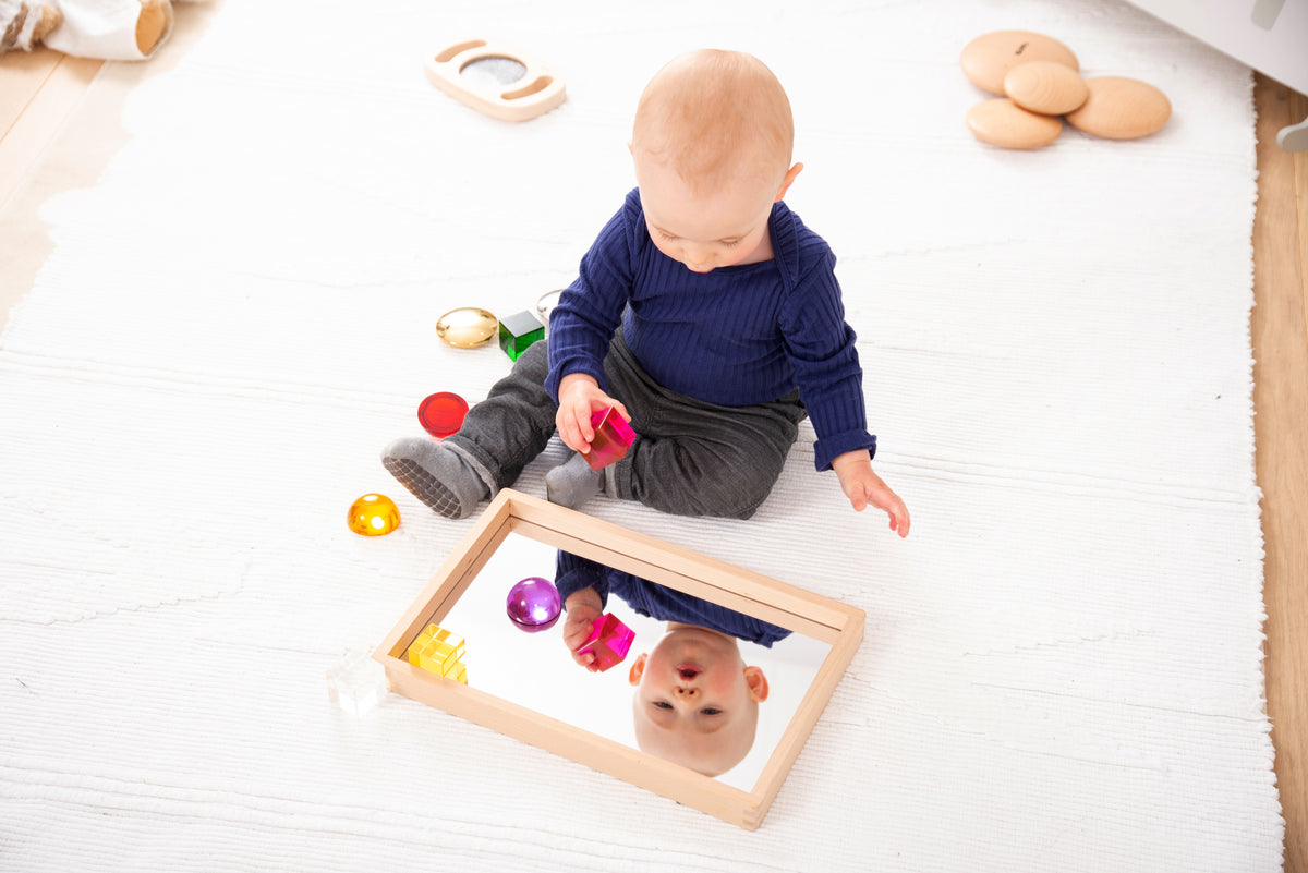 Small wooden mirror tray with mirrored bottom and colorful building blocks