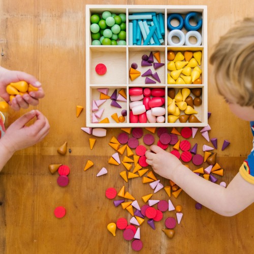 Wooden sorting tray filled with multicolor foam pieces