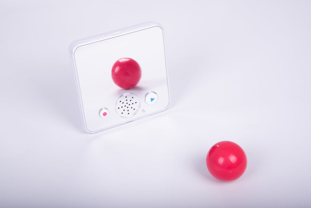 Clear-front sound-and-mirror device with red ball positioned near the sensor area