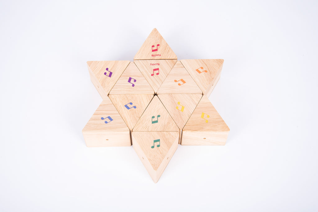 Wooden sound prism star of triangular blocks with colorful musical note decals