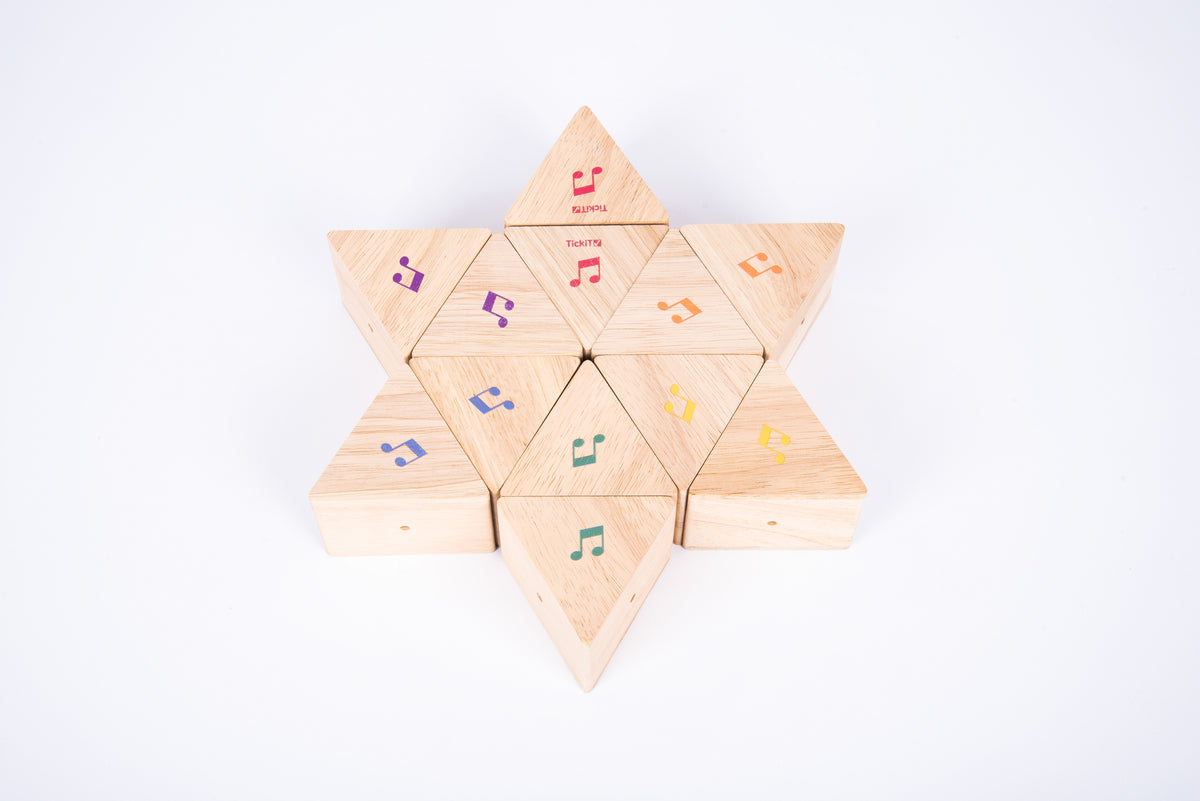 Wooden sound prism star of triangular blocks with colorful musical note decals