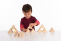 Wooden sound prism blocks set with musical note decals, child playing at table