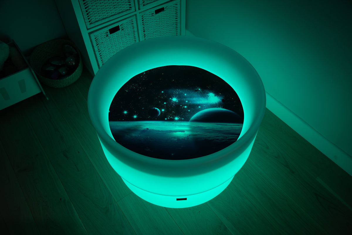 Round space play mat with blue glowing LED border and planet scene