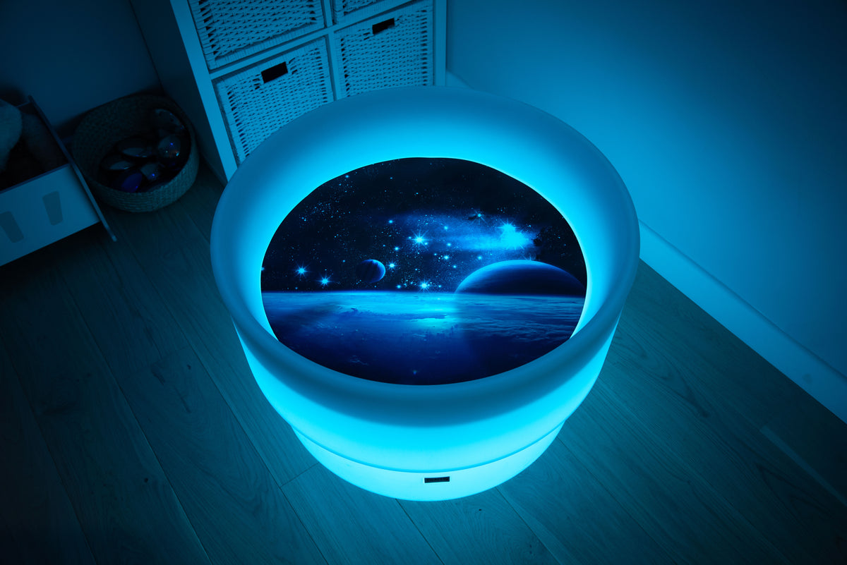 Round space play mat with blue glowing LED border and earthlike horizon