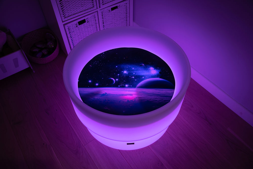 Round space play mat with purple glowing LED border and planet scene