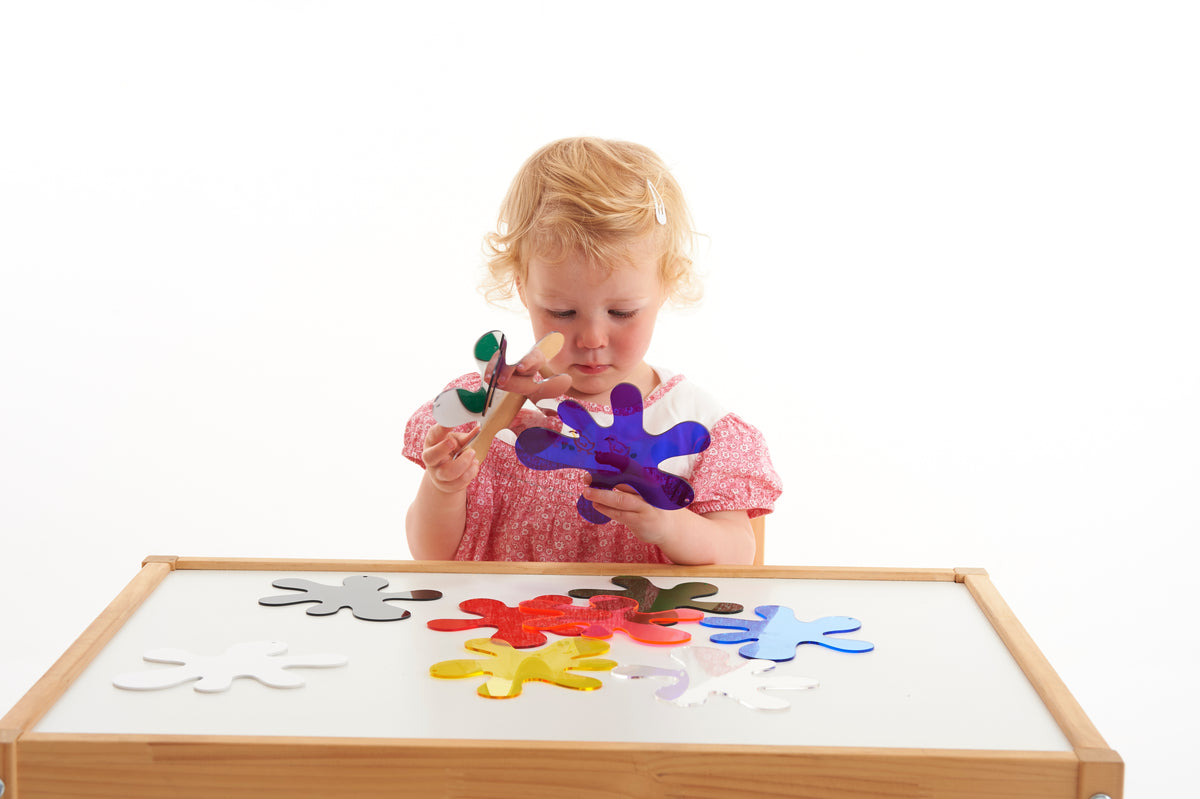 Colorful foam splash puzzle pieces scattered on a wooden frame board