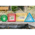 Stacking rainbow toy: nested shapes in green circle, red square, yellow rectangle, blue triangle