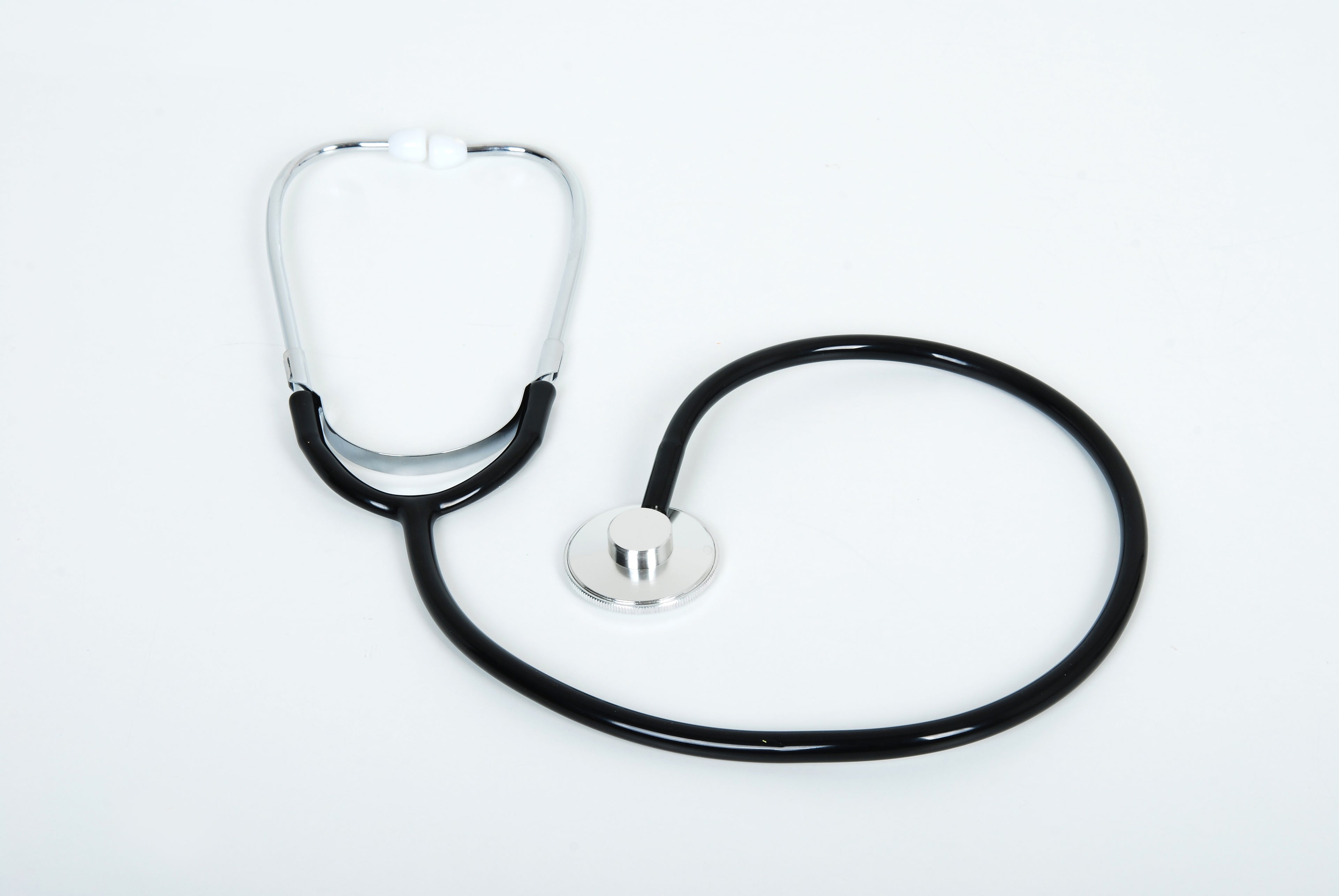 Medical stethoscope with chrome chestpiece and black tubing, one earpiece