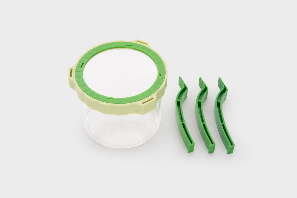 Tabletop magnifier cup with green lens ring and three attached side pieces