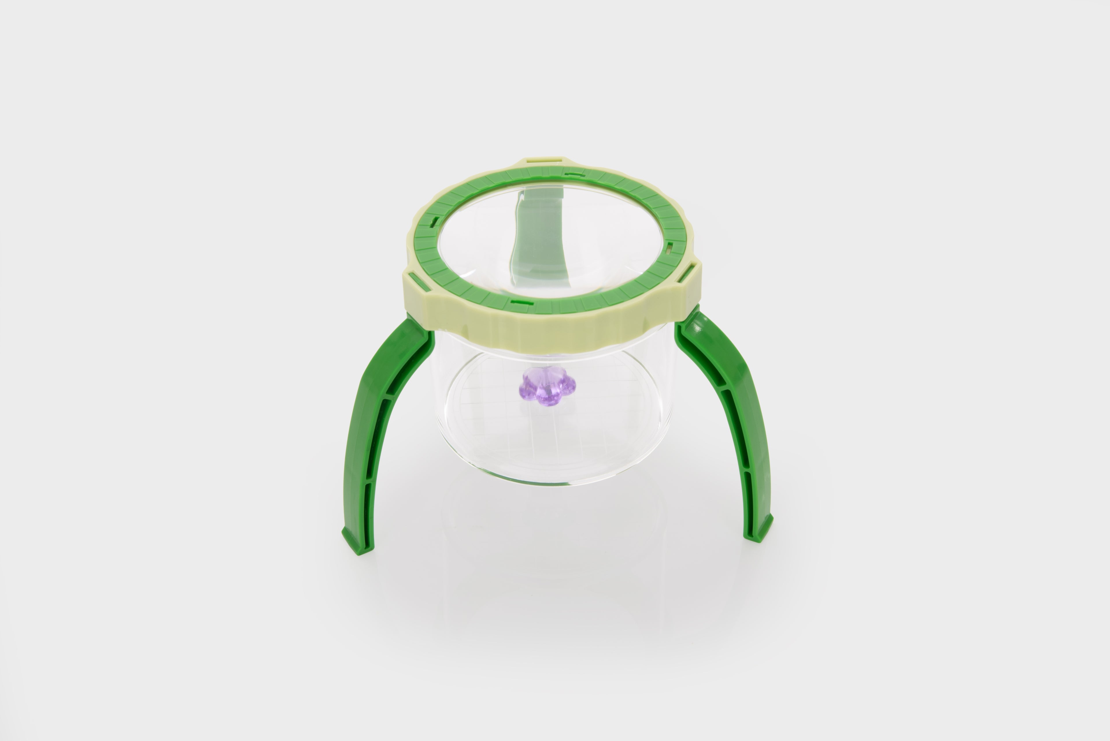 Green tabletop magnifier with clear glass lens and raised stand