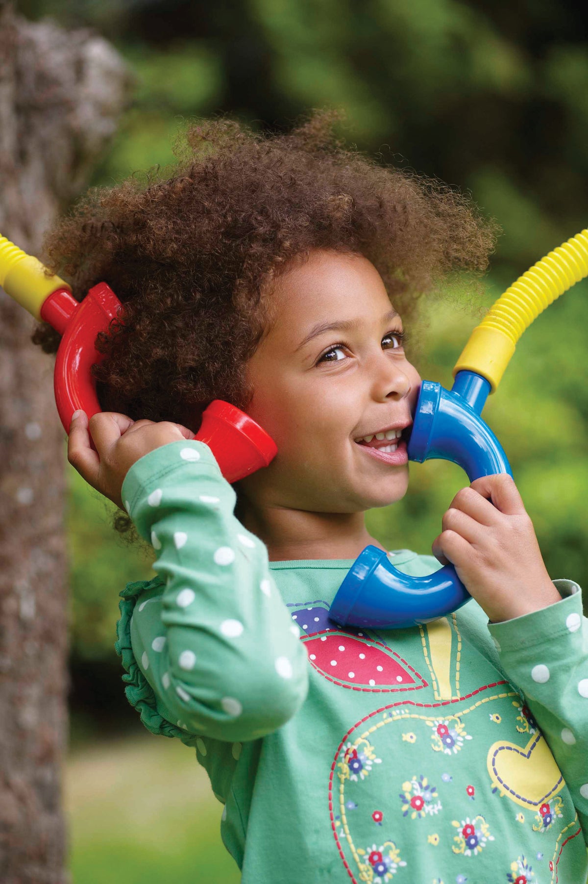 Kids using yellow talking tubes with red and blue end mouthpieces