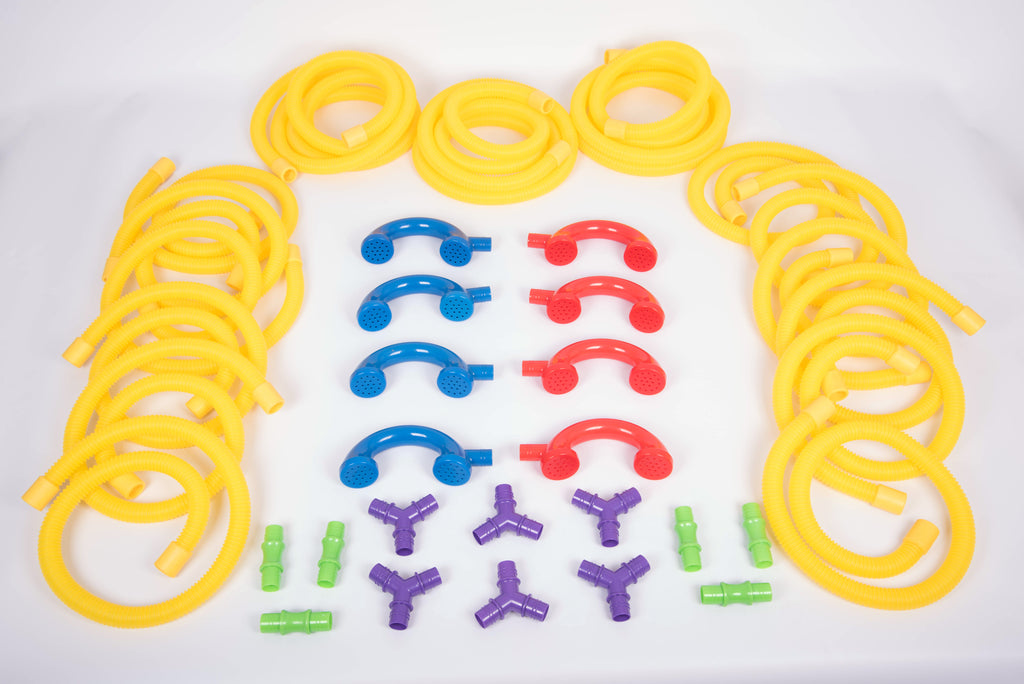 Flat lay of yellow talking tubes with blue, red, purple and green connector parts