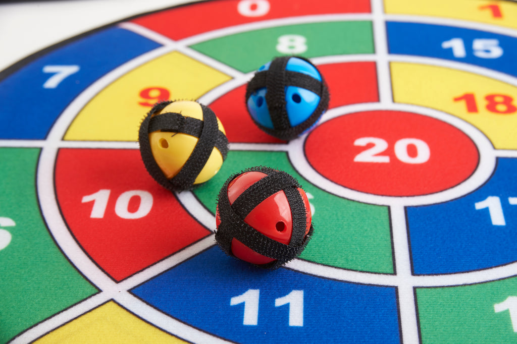 Foam math balls placed on a numbered dartboard target with blue and red markings