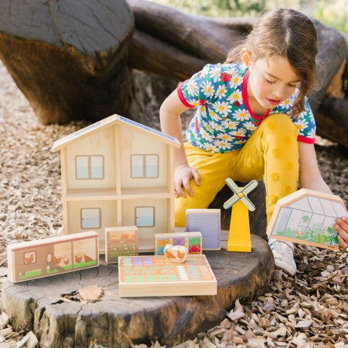 Wooden dollhouse playset with shutters and garden accessories, light beige