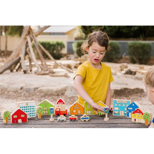 Wooden village playset with colorful houses, trees, and vehicles for children