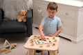 Wooden touch-and-match board with colorful pegs and circular matching holes