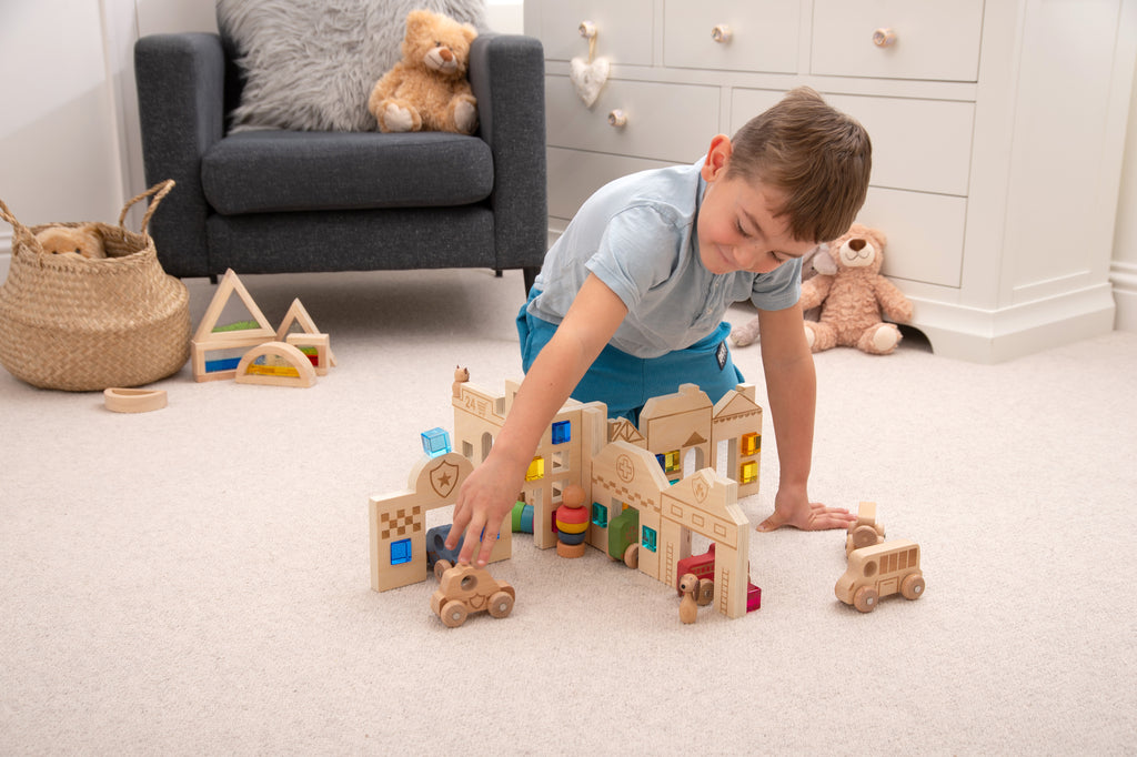 Town discovery dividers set with wooden town pieces as a child arranges cars and blocks