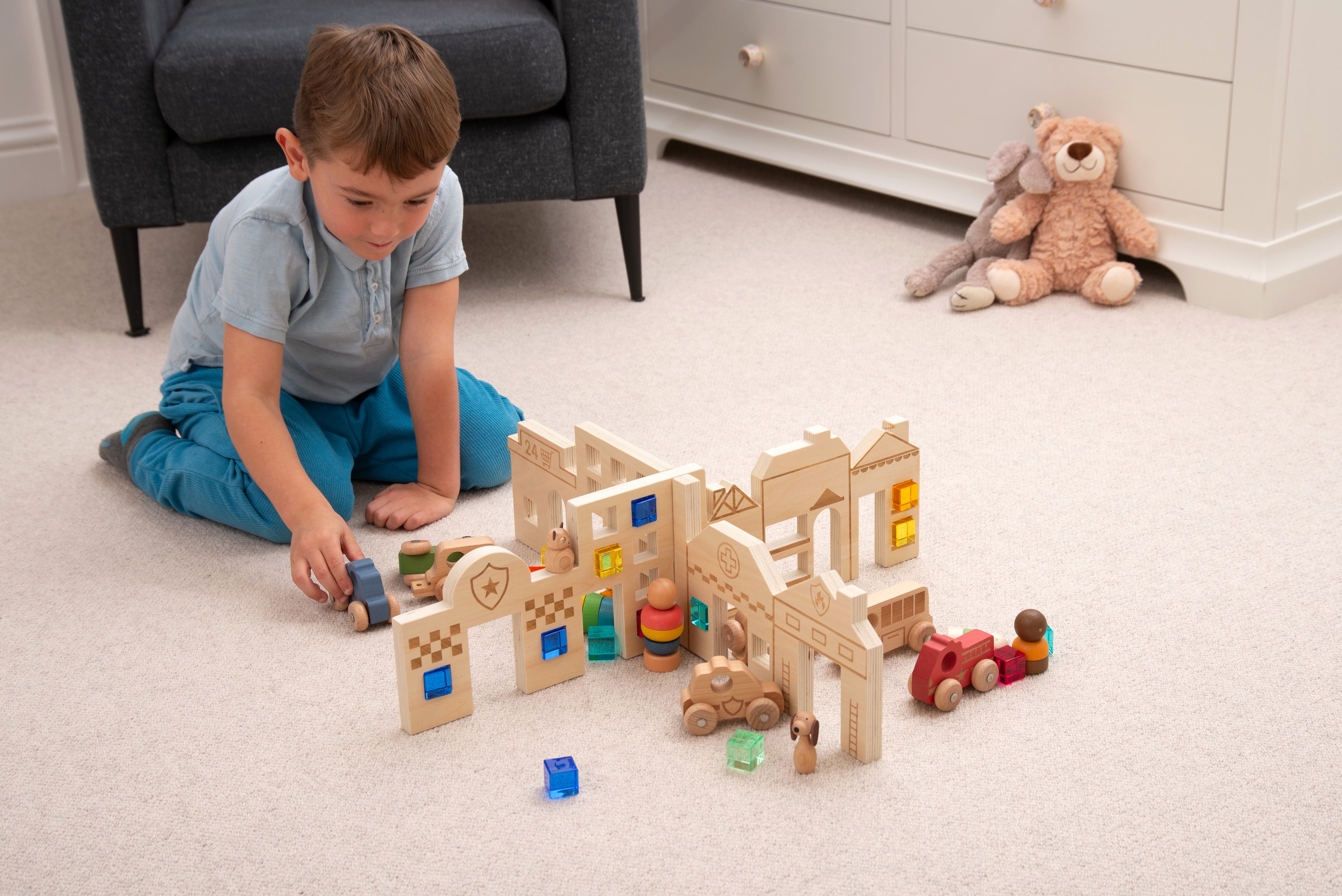 Town discovery dividers play set with wooden buildings and toy cars arranged on the floor