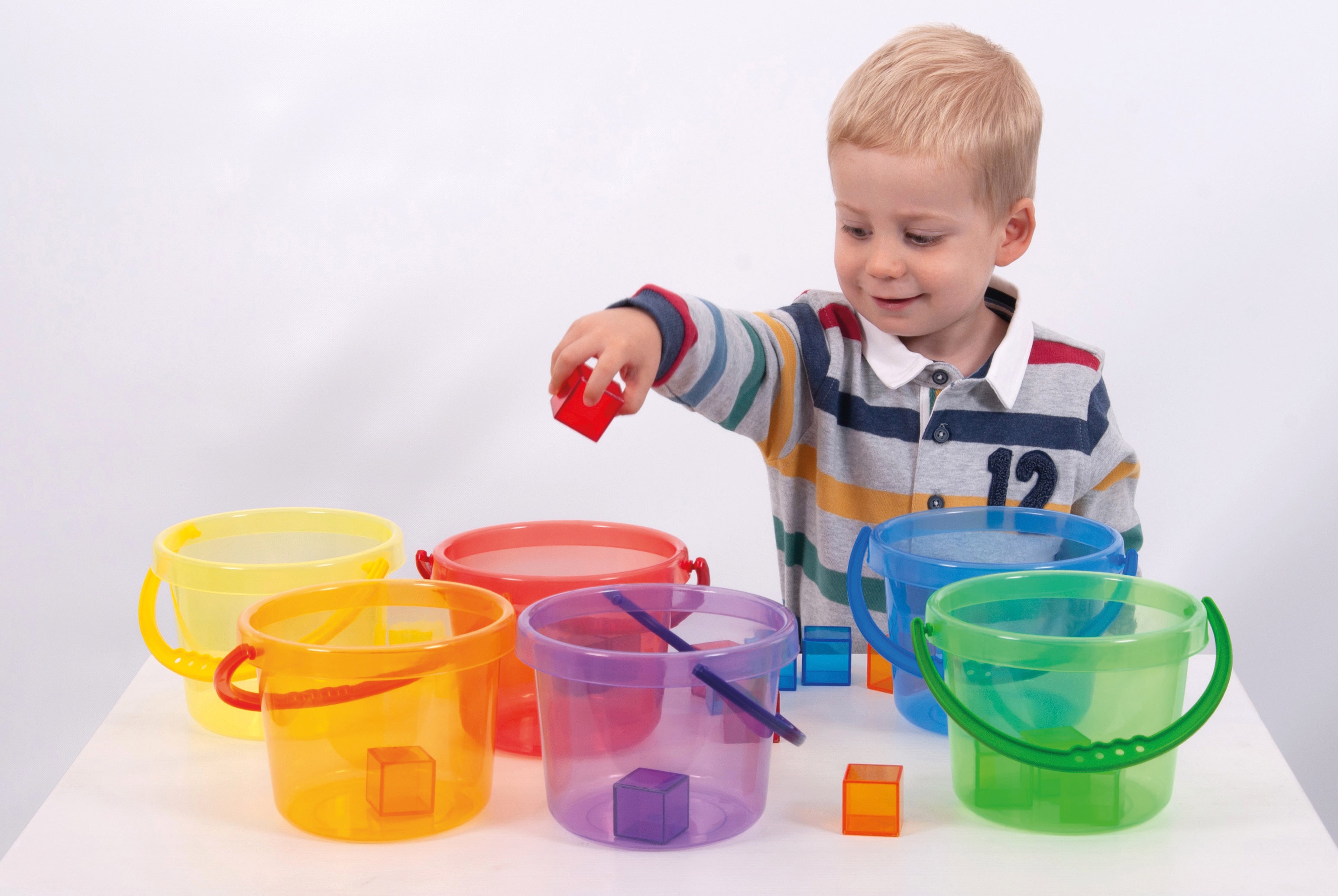 Translucent bucket set with colorful lidded buckets, plus small blocks on table
