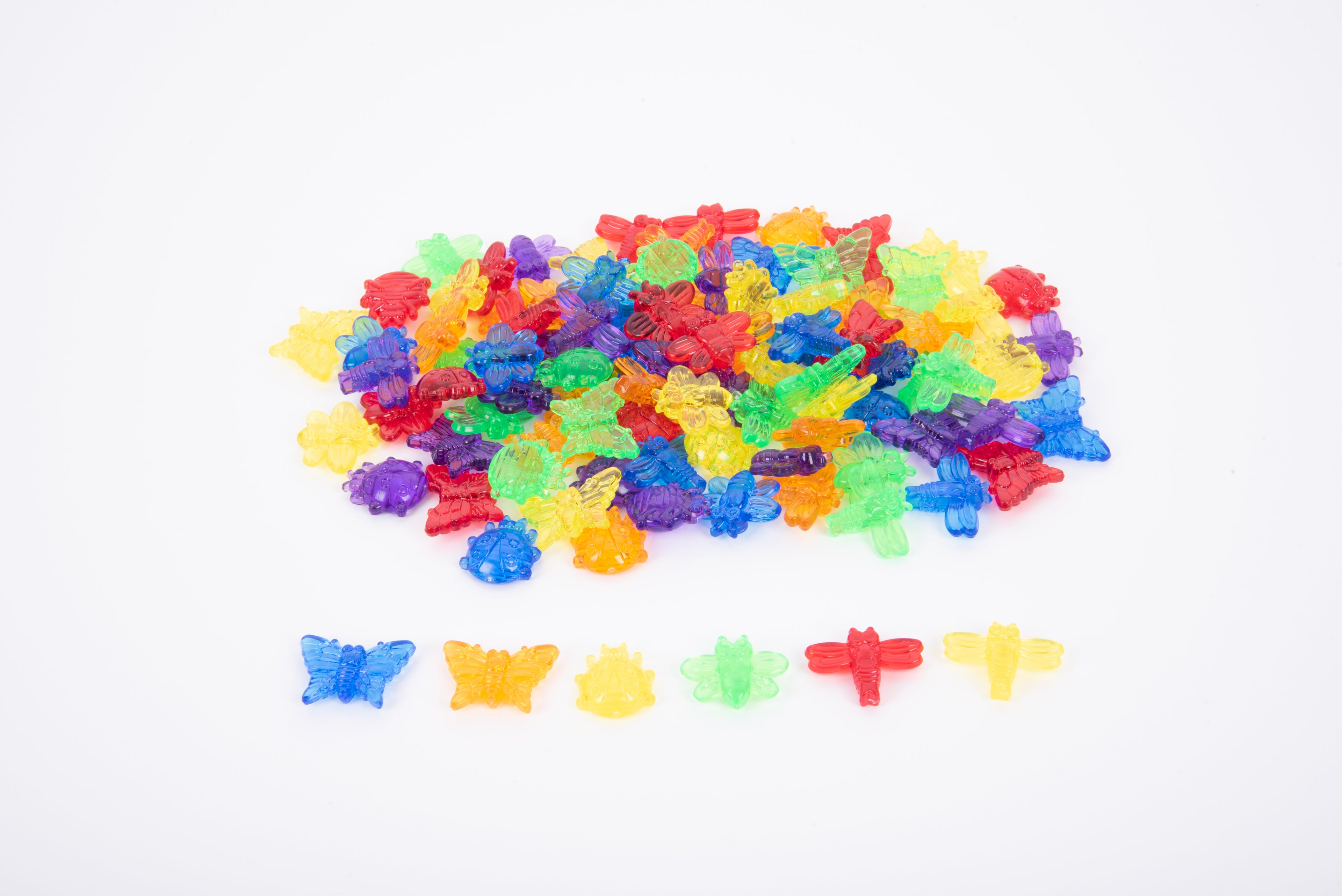 Translucent colorful bug pieces in rainbow pile, plus small mixed shapes.