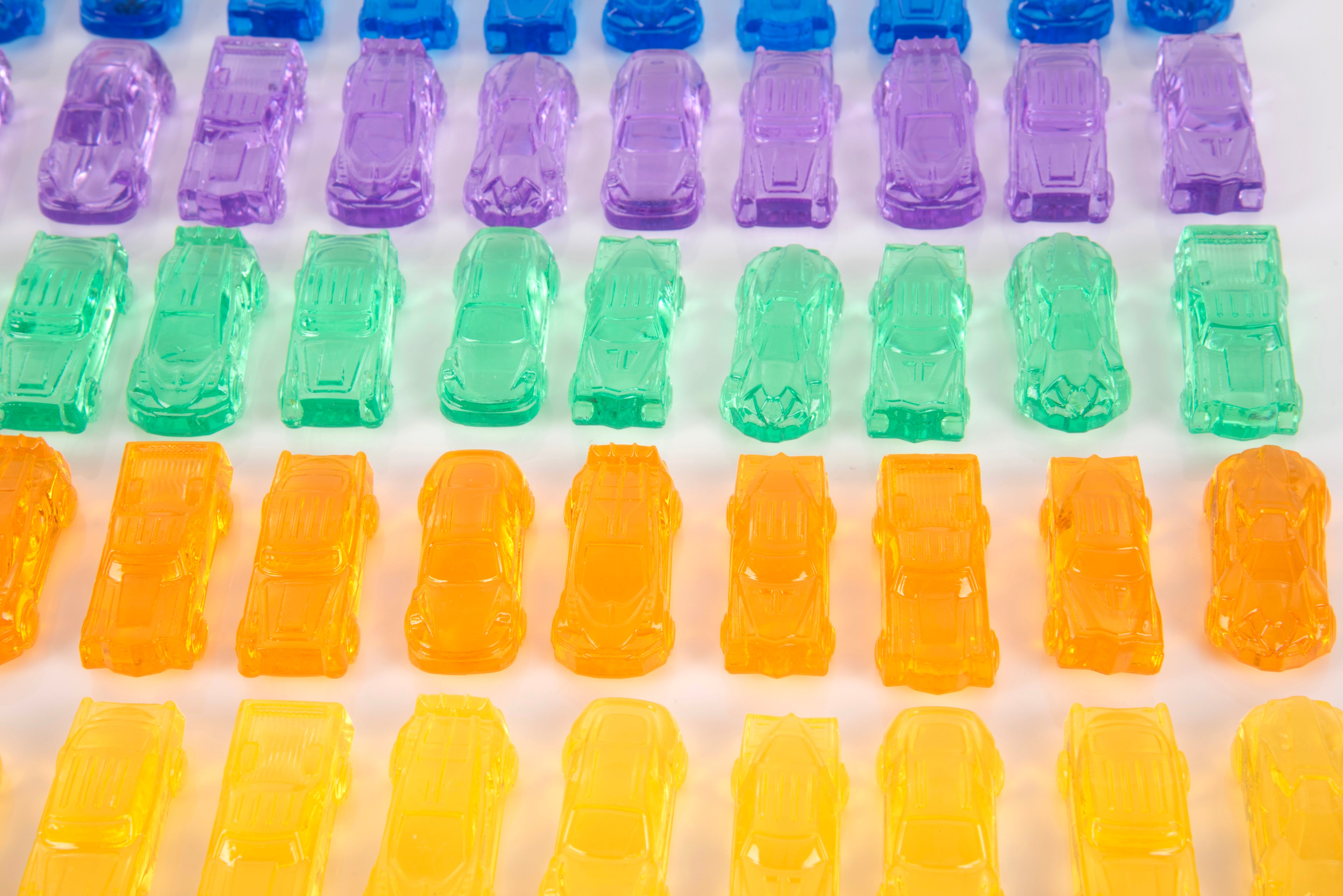Translucent multicolor toy car set, rows of small plastic cars