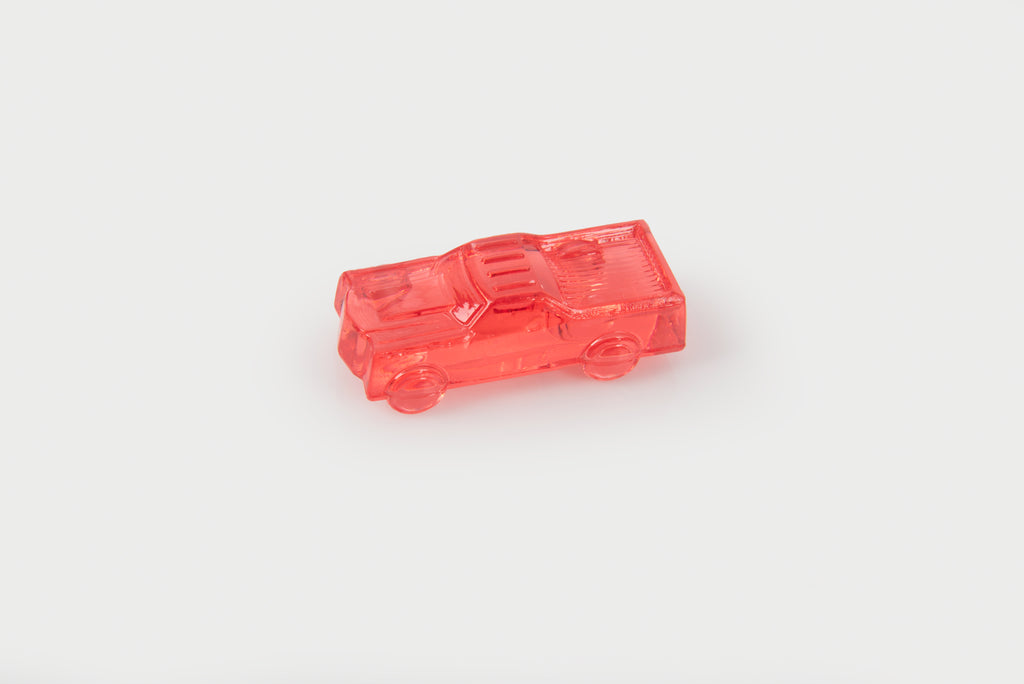 Translucent red toy car with detailed window and wheel features