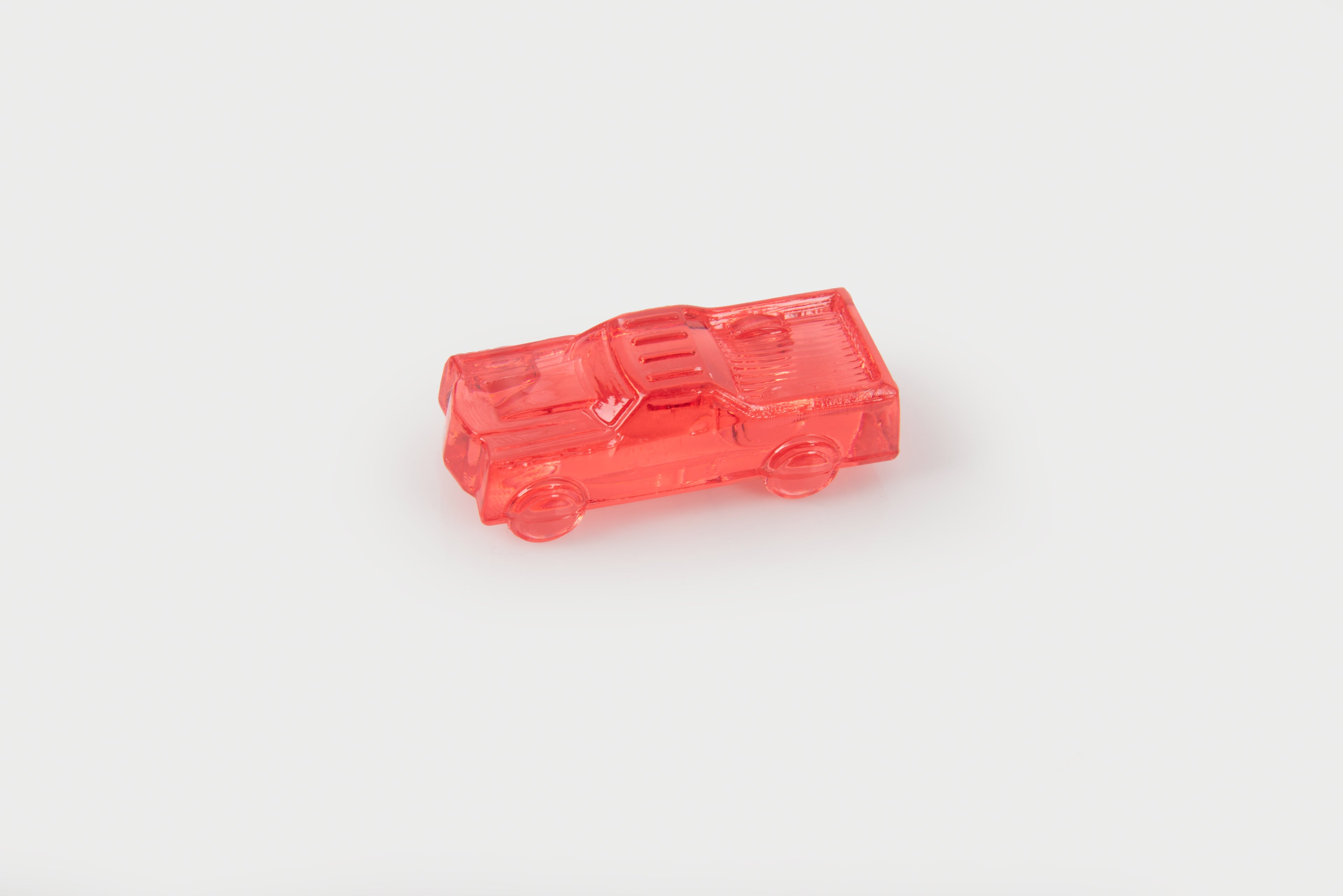 Translucent red toy car with detailed window and wheel features