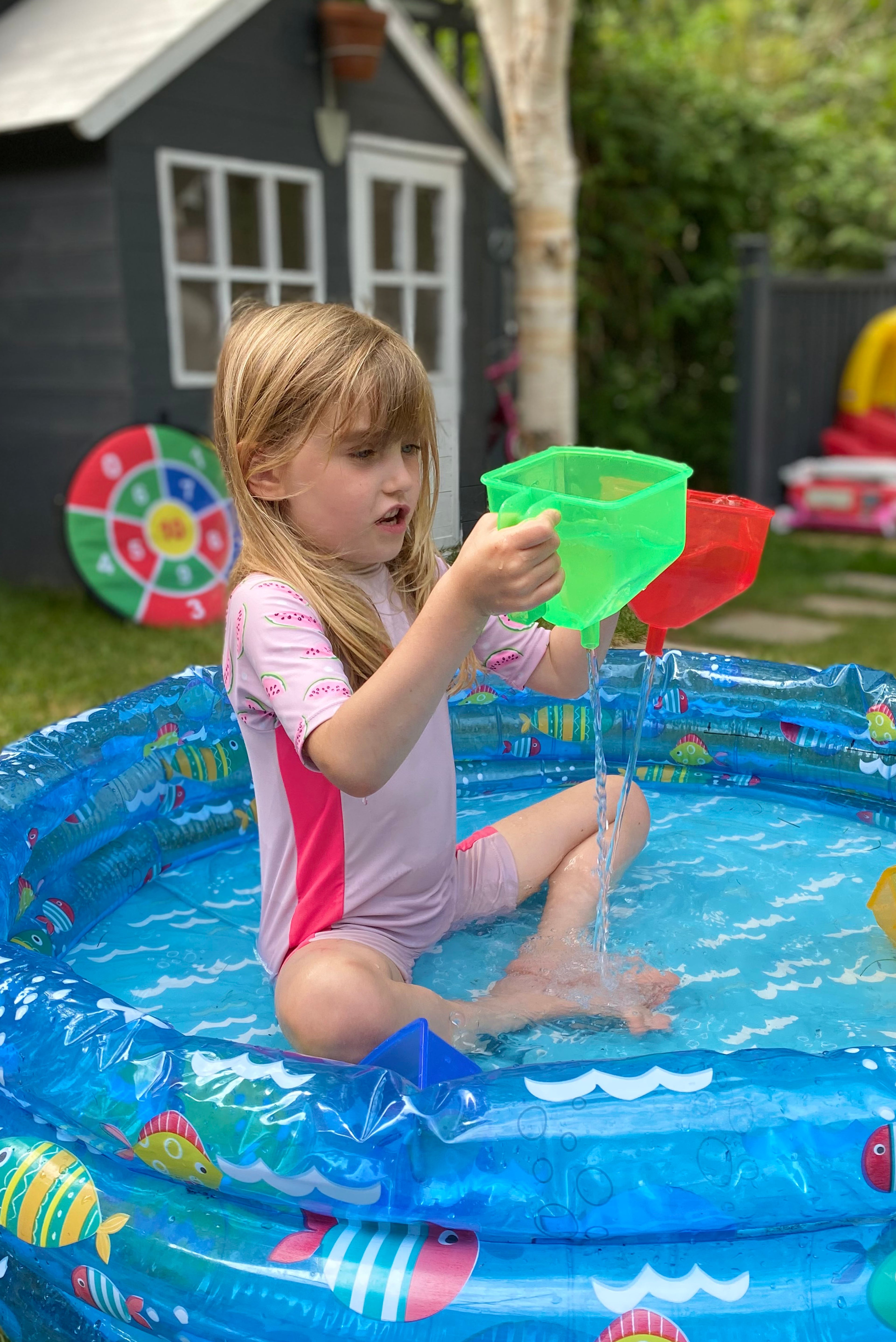 Translucent color funnels: green and red funnel with pouring spout in a pool