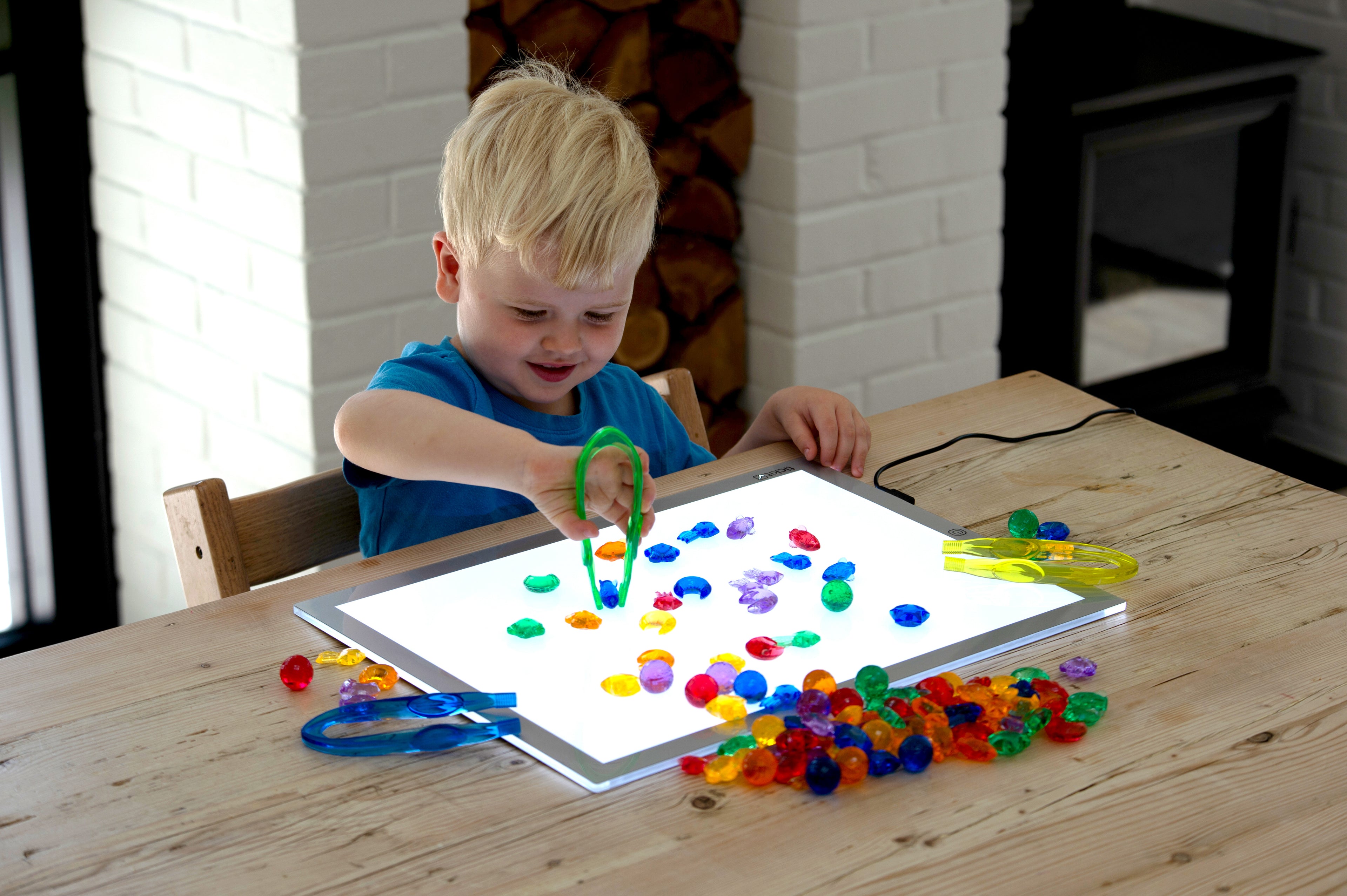 Translucent color bead set on a flat tray with scattered round beads and scoops