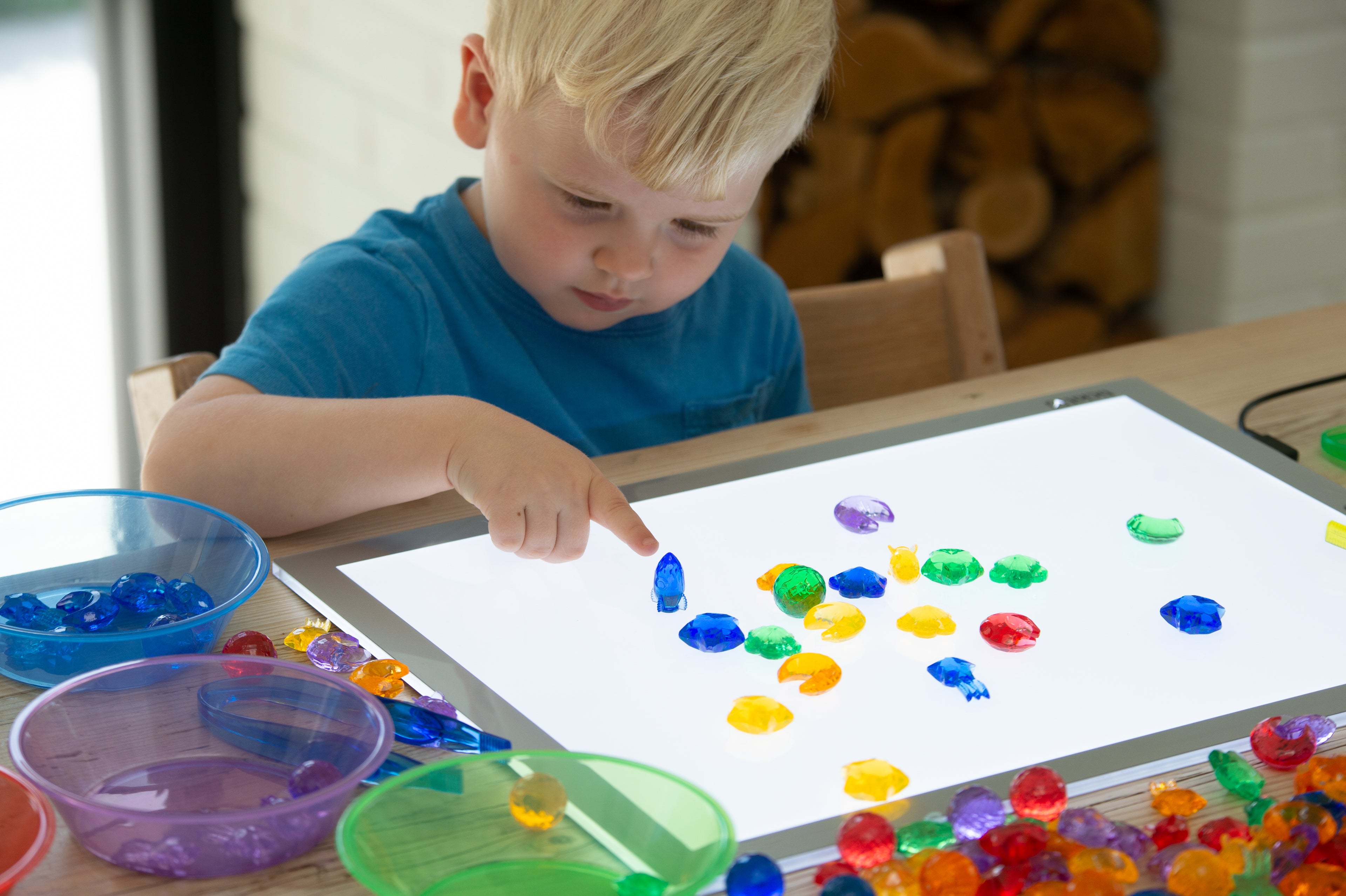 Translucent bead set close-up on a tray with multicolor round beads and scoops
