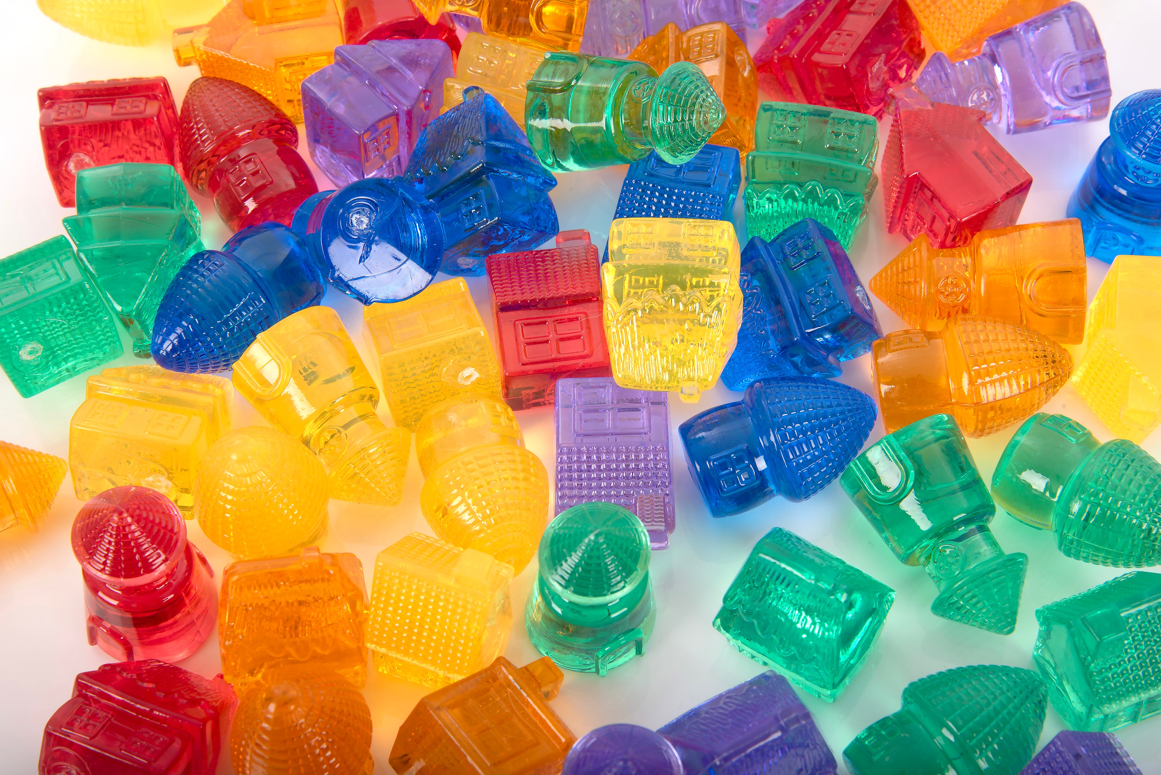 Many translucent colorful toy house blocks, mixed red, orange, yellow, blue, green