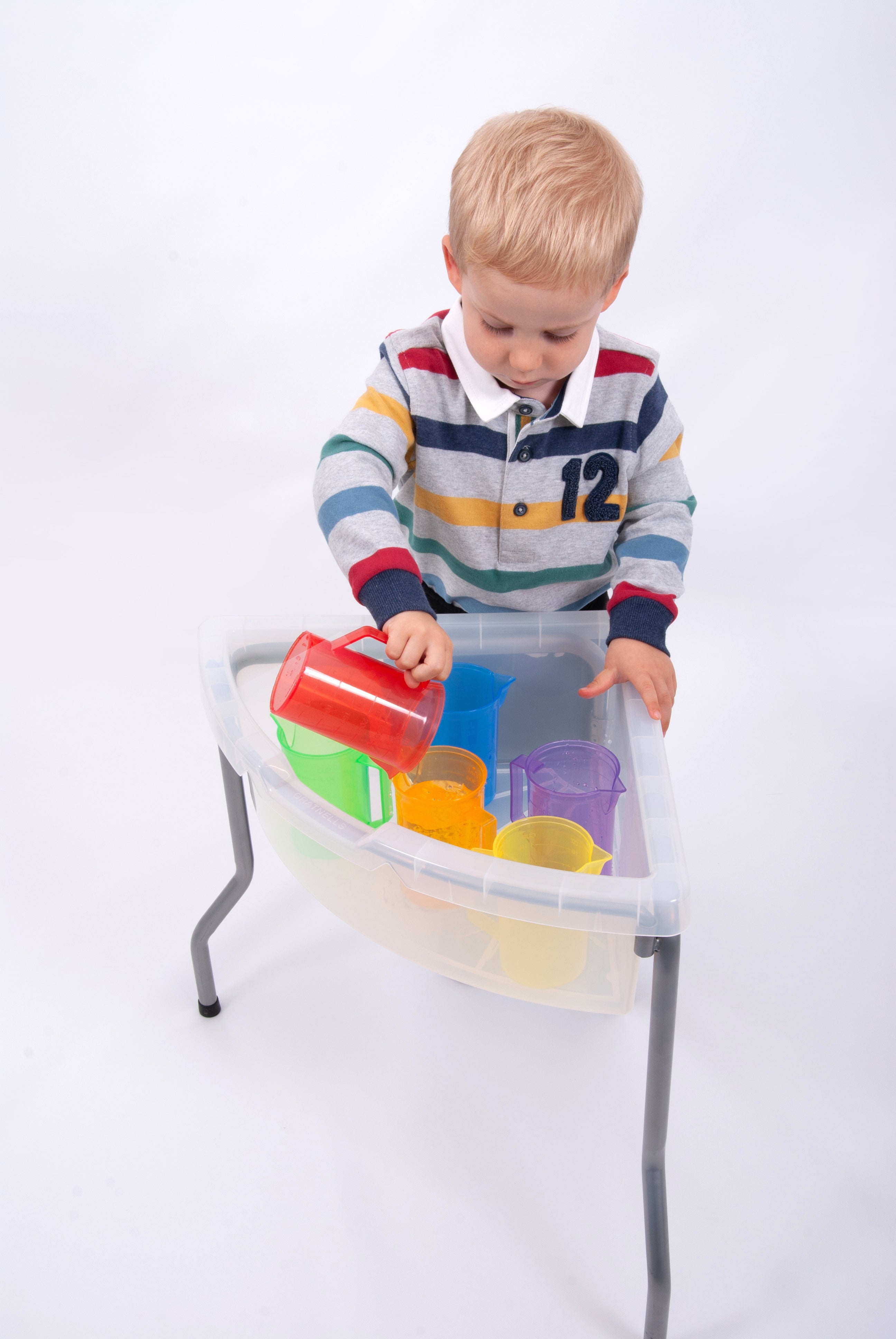 Translucent plastic jug set with red, green, yellow and purple jugs in a clear bin