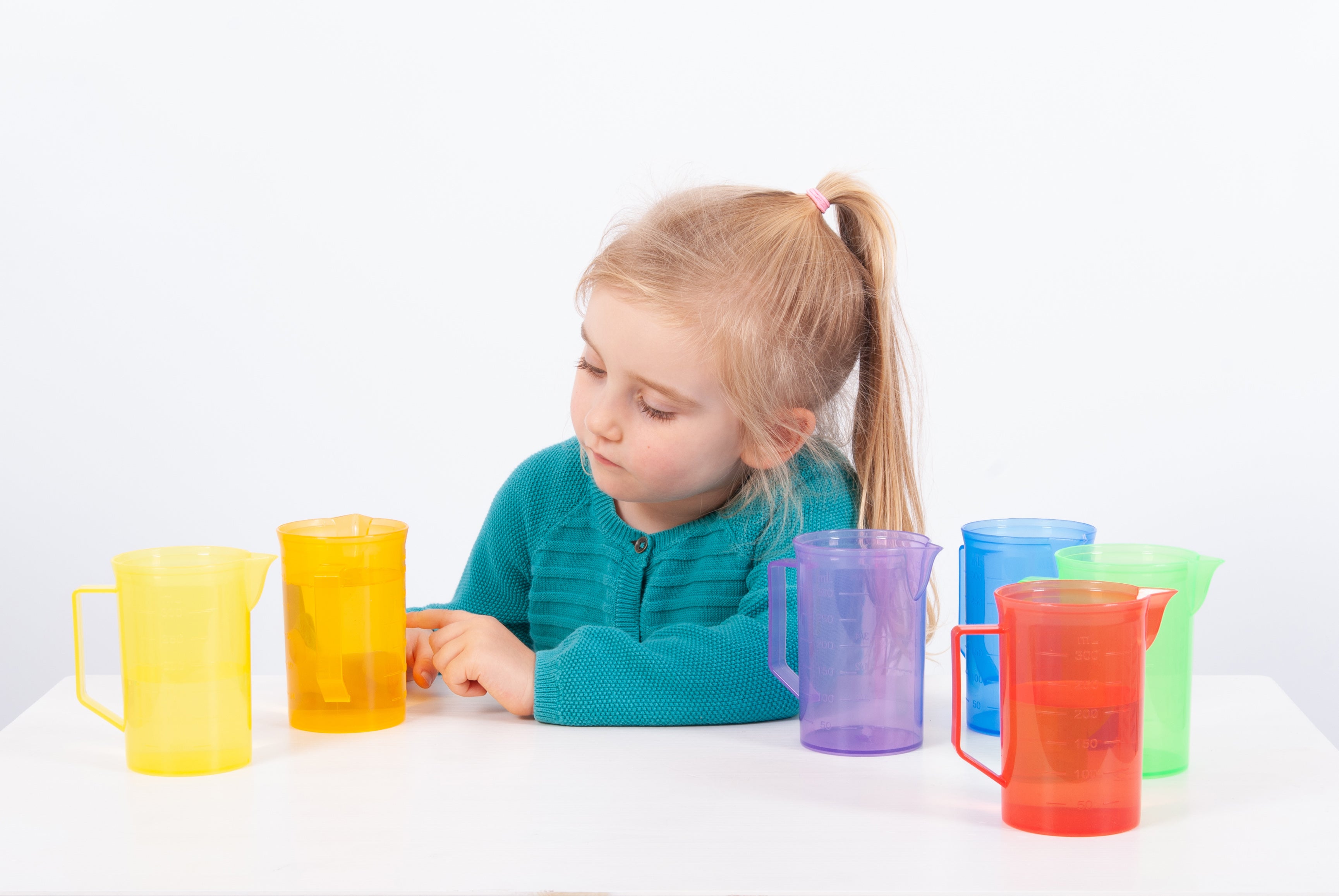 Translucent plastic jugs in yellow, purple, red, green and blue with handles