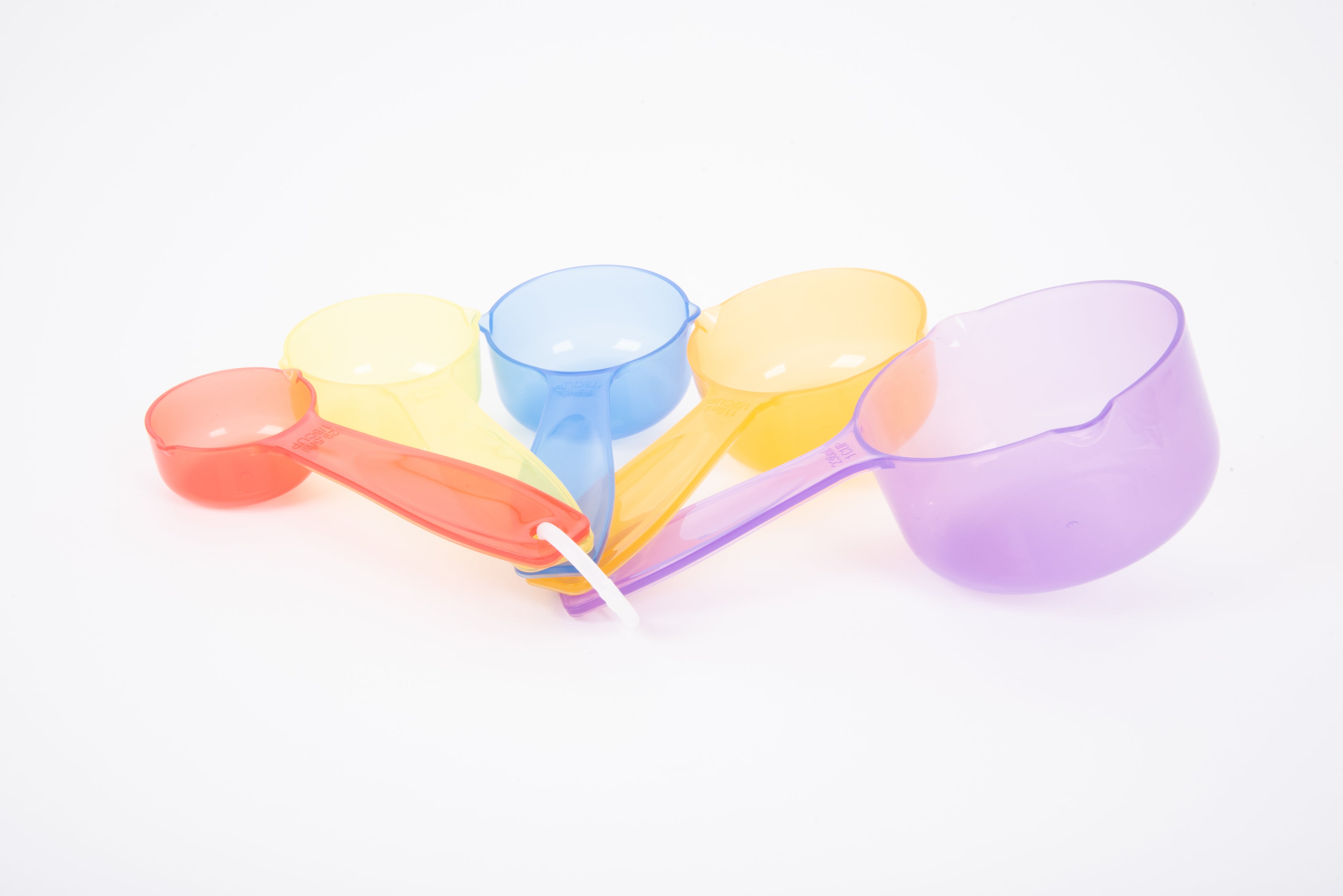 Translucent measuring cup set with long yellow, red, and purple handles and round cup bowls