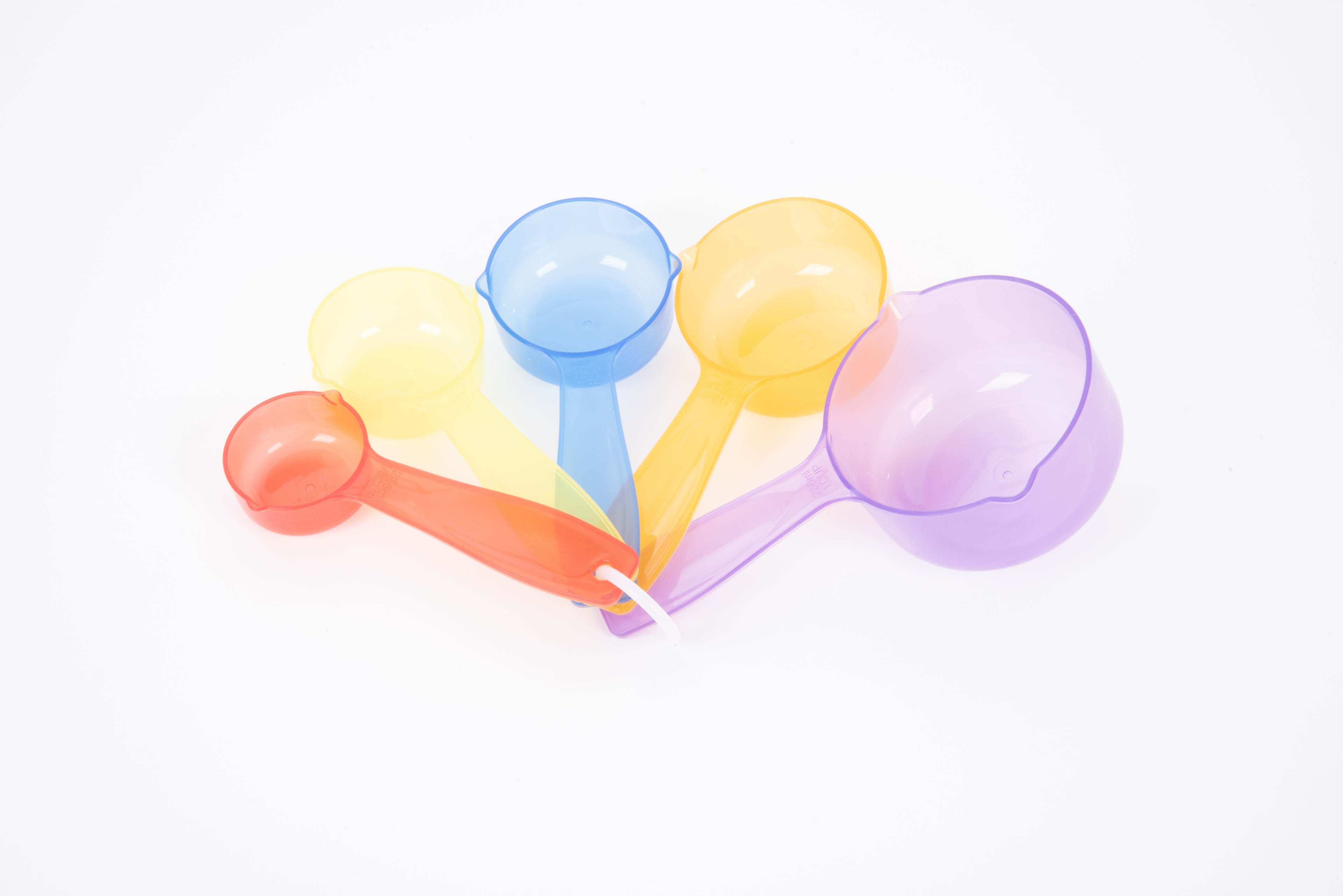 Translucent measuring cups with different colored round bowls and long handles, purple and orange