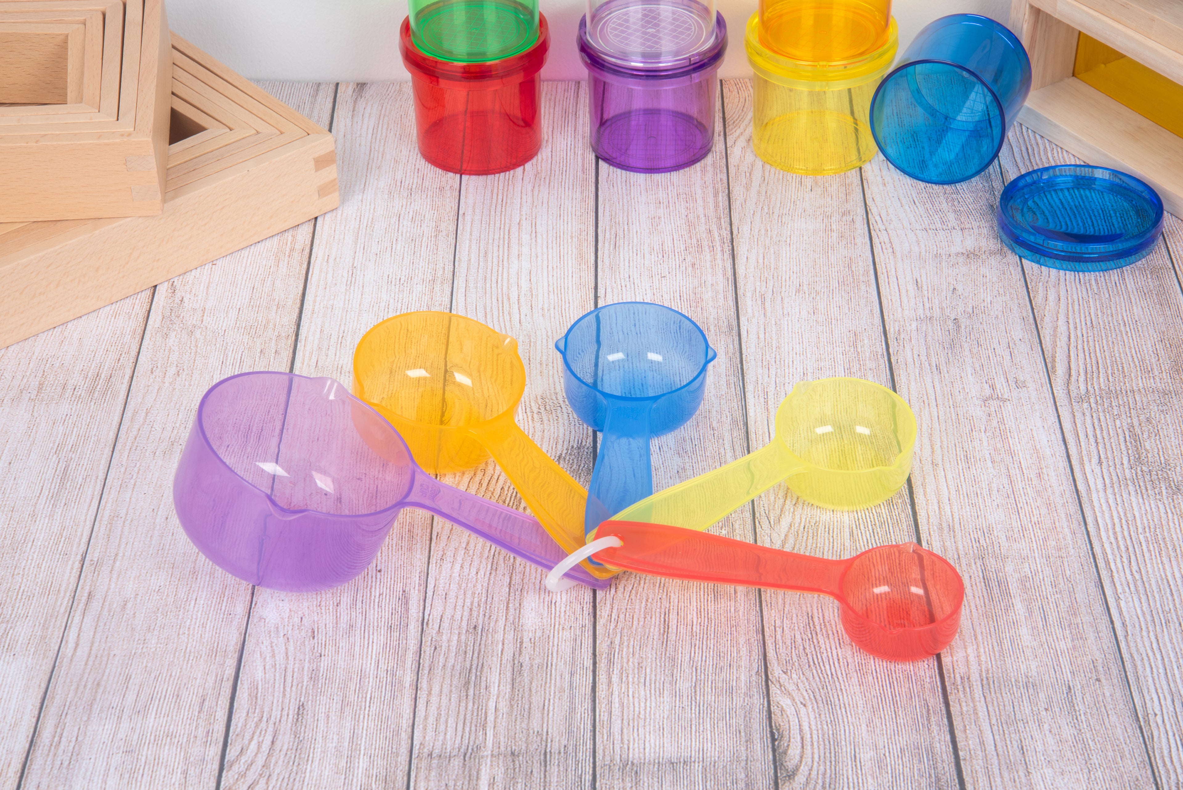Translucent measuring cup set with colored round bowls and handles, blue purple and orange
